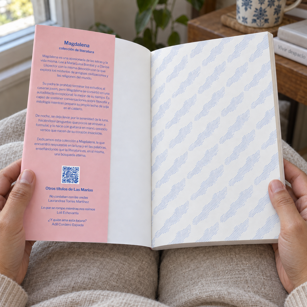 An open book held by two hands, showing a Spanish-language devotional booklet titled 'Magdalena colección literaria.' The left page is pink with printed text and a QR code, while the right page has a pale blue and white diagonal striped pattern.